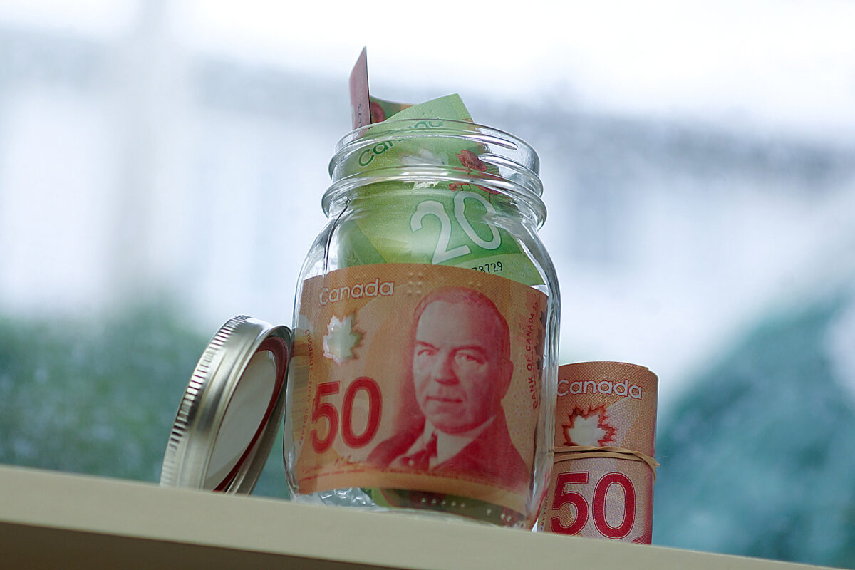 Canadian money in glass jar